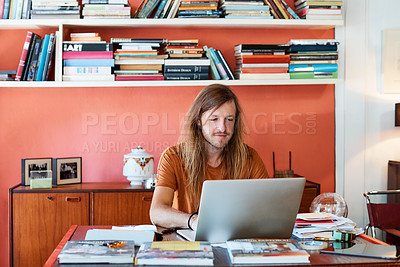 Buy stock photo Cropped shot of a man working on his laptop in a modern office