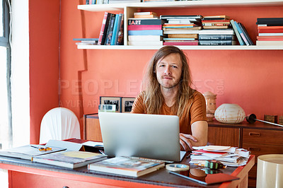 Buy stock photo Cropped portrait of a man working on his laptop in a modern office