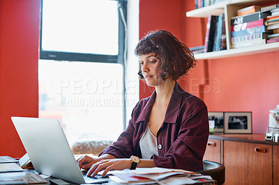 Buy stock photo Cropped shot of a young woman sitting behind her laptop in the office