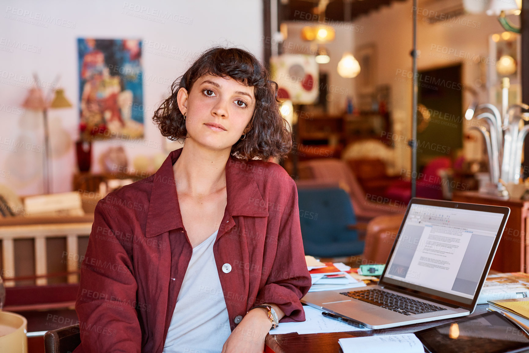 Buy stock photo Cropped portrait of an attractive young woman sitting at her desk in an office