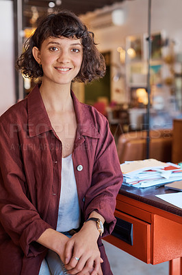 Buy stock photo Cropped portrait of an attractive young woman sitting at her desk in the office