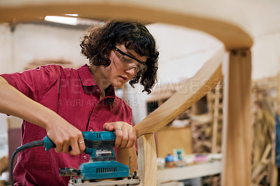 Buy stock photo Shot of a woman working with wood in a furniture manufacturing workshop