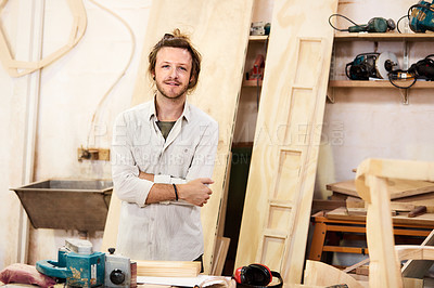 Buy stock photo Shot of a man working with wood in a furniture manufacturing workshop