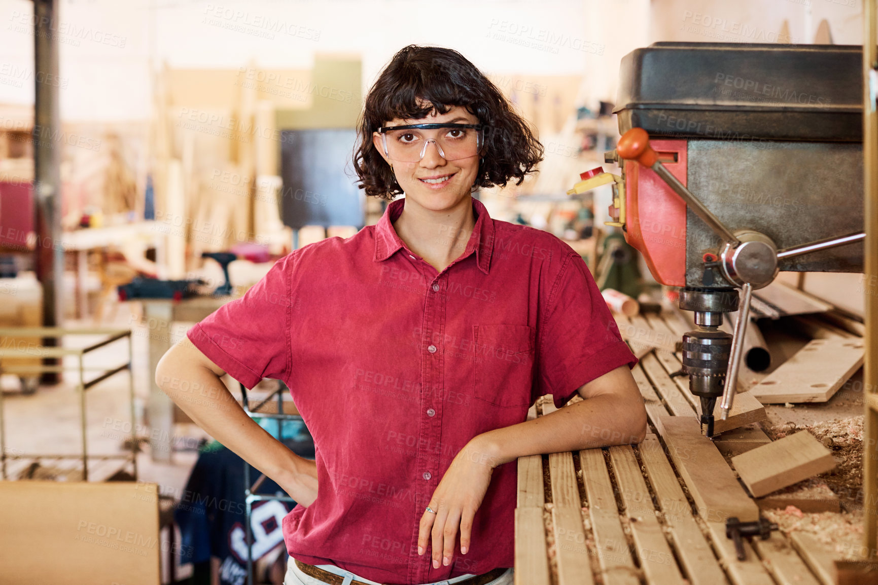 Buy stock photo Shot of a woman working with wood in a furniture manufacturing workshop