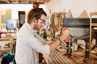 Buy stock photo Shot of a man working with wood in a furniture manufacturing workshop