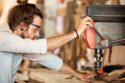 Buy stock photo Shot of a man working with wood in a furniture manufacturing workshop