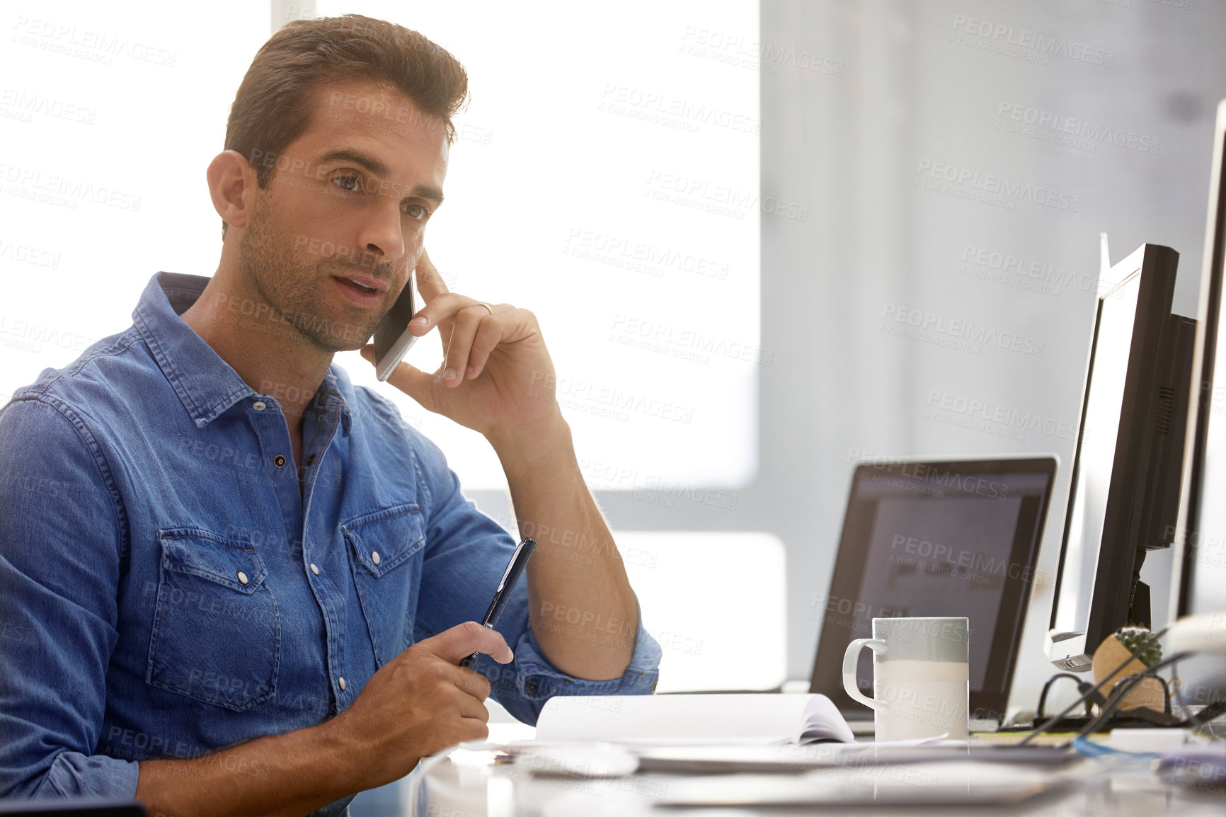 Buy stock photo Shot of a businessman using his cellphone in his office