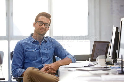 Buy stock photo Portrait of a handsome businessman sitting at his desk