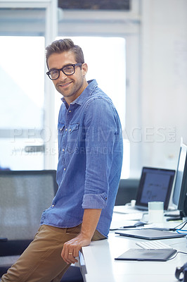 Buy stock photo Shot of a handsome young businessman in his office
