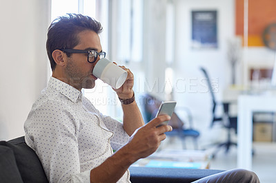Buy stock photo Shot of a businessman using his cellphone in his office