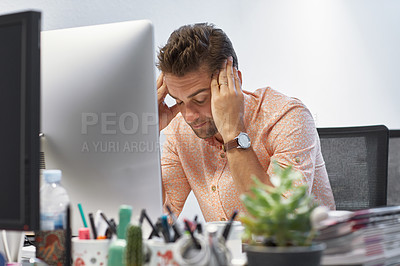Buy stock photo Cropped shot of a businessman looking stressed while sitting at his desk