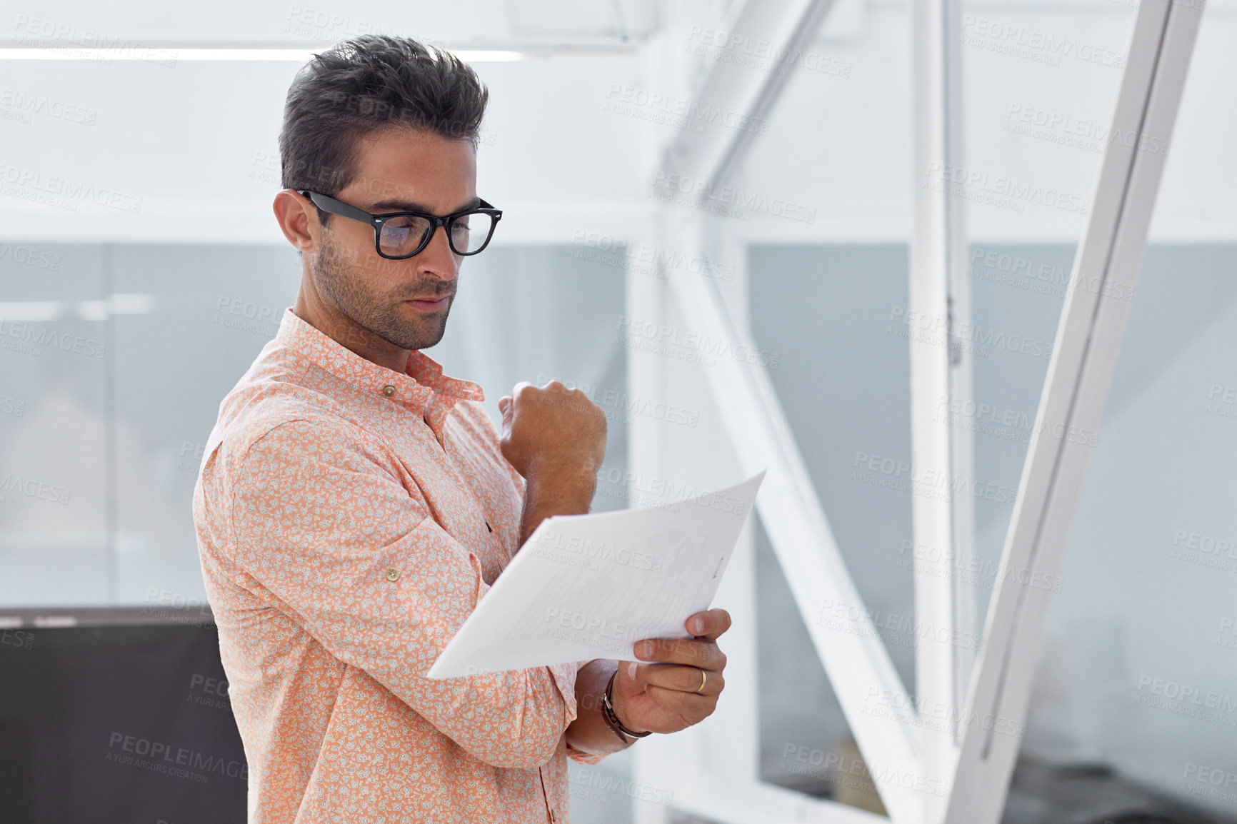 Buy stock photo Cropped shot of a businessman going over some paperwork