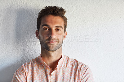 Buy stock photo Cropped shot of a handsome young businessman posing against a white wall