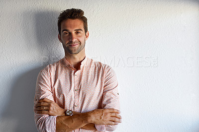 Buy stock photo Cropped shot of a handsome young businessman posing against a white wall
