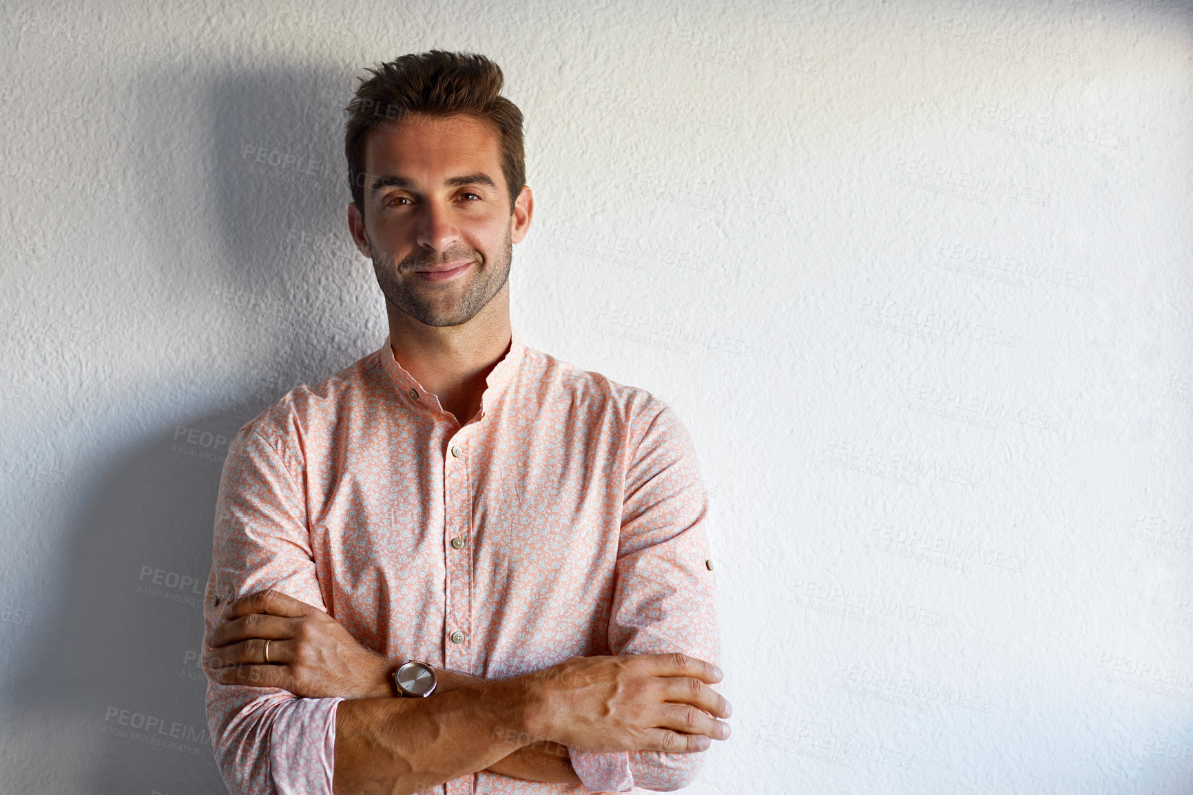 Buy stock photo Cropped shot of a handsome young businessman posing against a white wall