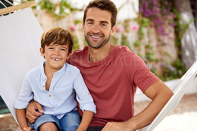 Buy stock photo Portrait of a father and son relaxing together on a hammock outside