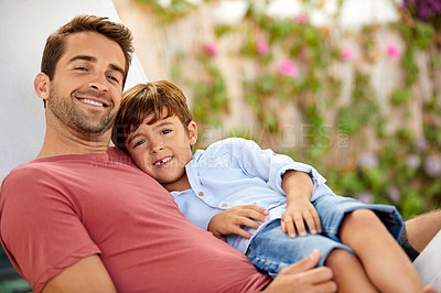 Buy stock photo Portrait of a father and son relaxing together on a hammock outside
