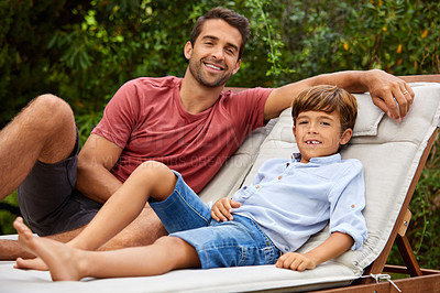 Buy stock photo Portrait of a father and son relaxing together outside
