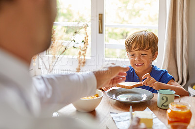 Buy stock photo Cropped shot of a young family having breakfast together at home