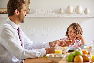 Buy stock photo Cropped shot of a young family having breakfast together at home