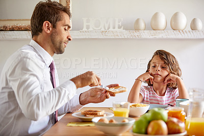 Buy stock photo Cropped shot of a young family having breakfast together at home