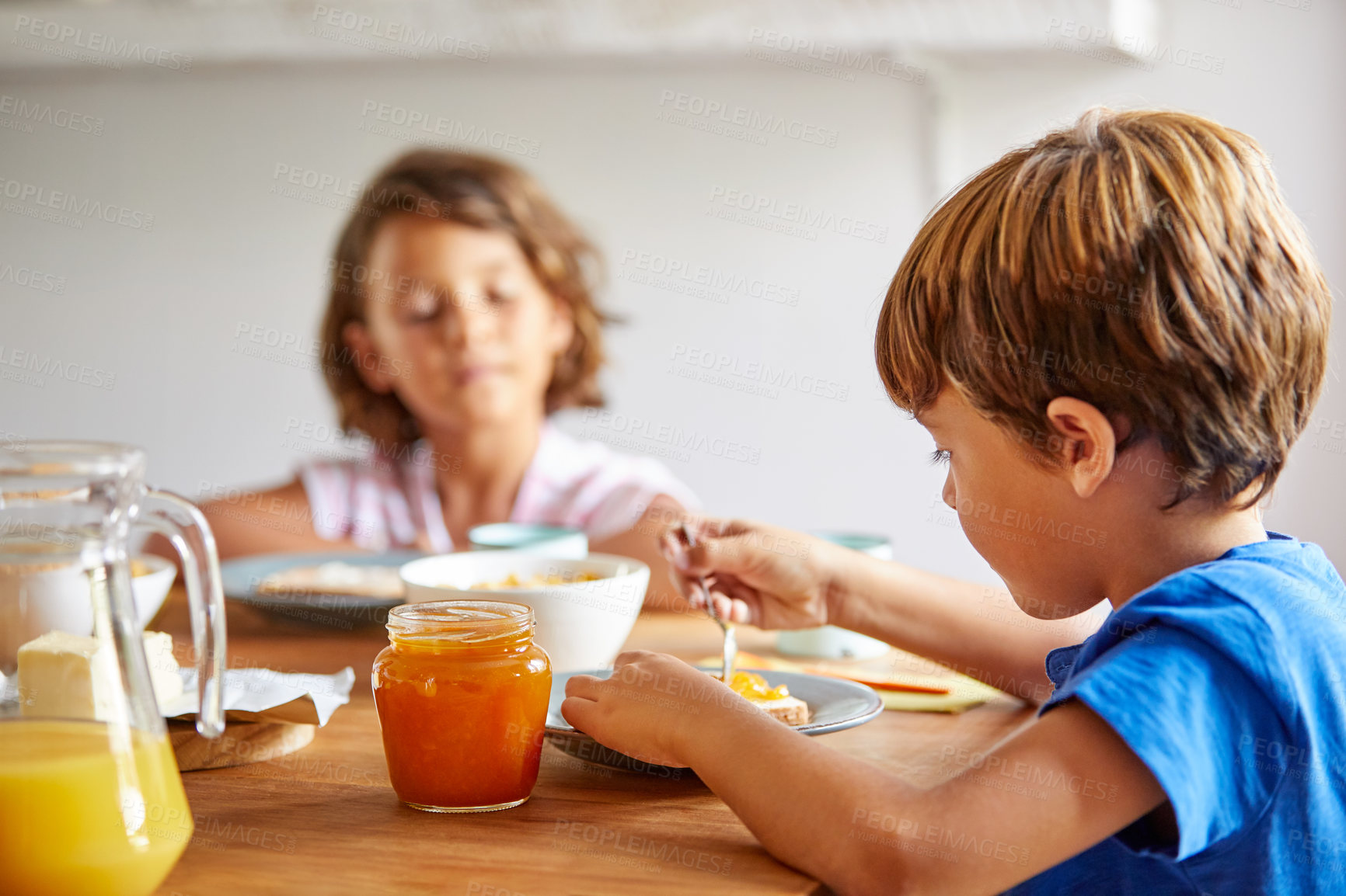 Buy stock photo Cropped shot of siblings having breakfast together at home