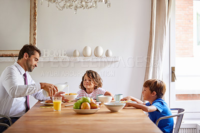 Buy stock photo Cropped shot of a young family having breakfast together at home