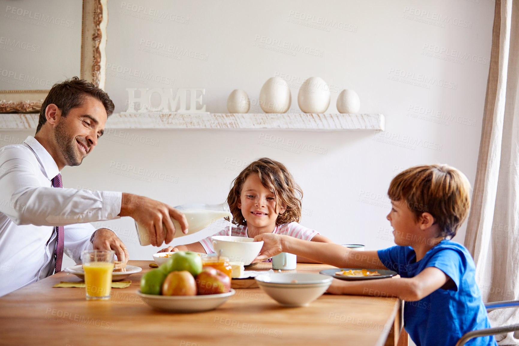Buy stock photo Cropped shot of a young family having breakfast together at home