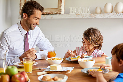 Buy stock photo Cropped shot of young children having breakfast at home