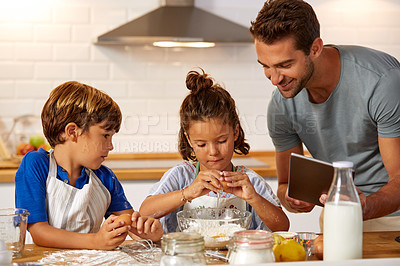 Buy stock photo Cropped shot of a father helping his son and daughter bake in the kitchen at home