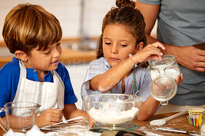 Buy stock photo Cropped shot of an adorable brother and sister baking in the kitchen