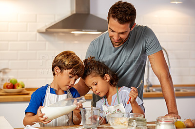 Buy stock photo Cropped shot of a father helping his son and daughter bake in the kitchen at home