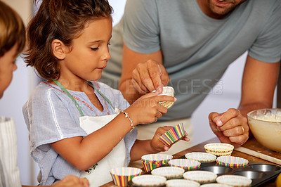 Buy stock photo Cropped shot of a father helping his son and daughter bake in the kitchen at home