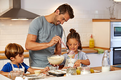 Buy stock photo Cropped shot of a father helping his son and daughter bake in the kitchen at home