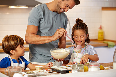 Buy stock photo Cropped shot of a father helping his son and daughter bake in the kitchen at home