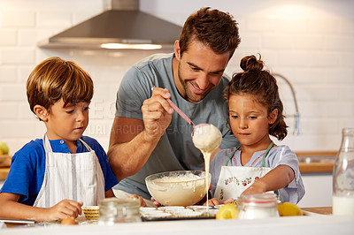 Buy stock photo Cropped shot of a father helping his son and daughter bake in the kitchen at home