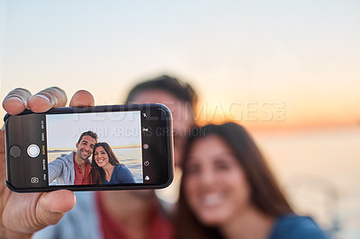 Buy stock photo Shot of a young couple taking a selfie together on an ocean cruise