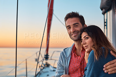 Buy stock photo Shot of a young couple enjoying a cruise out on the ocean