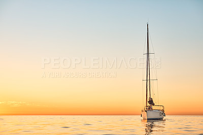 Buy stock photo Shot of a young couple going for an ocean cruise at sunset