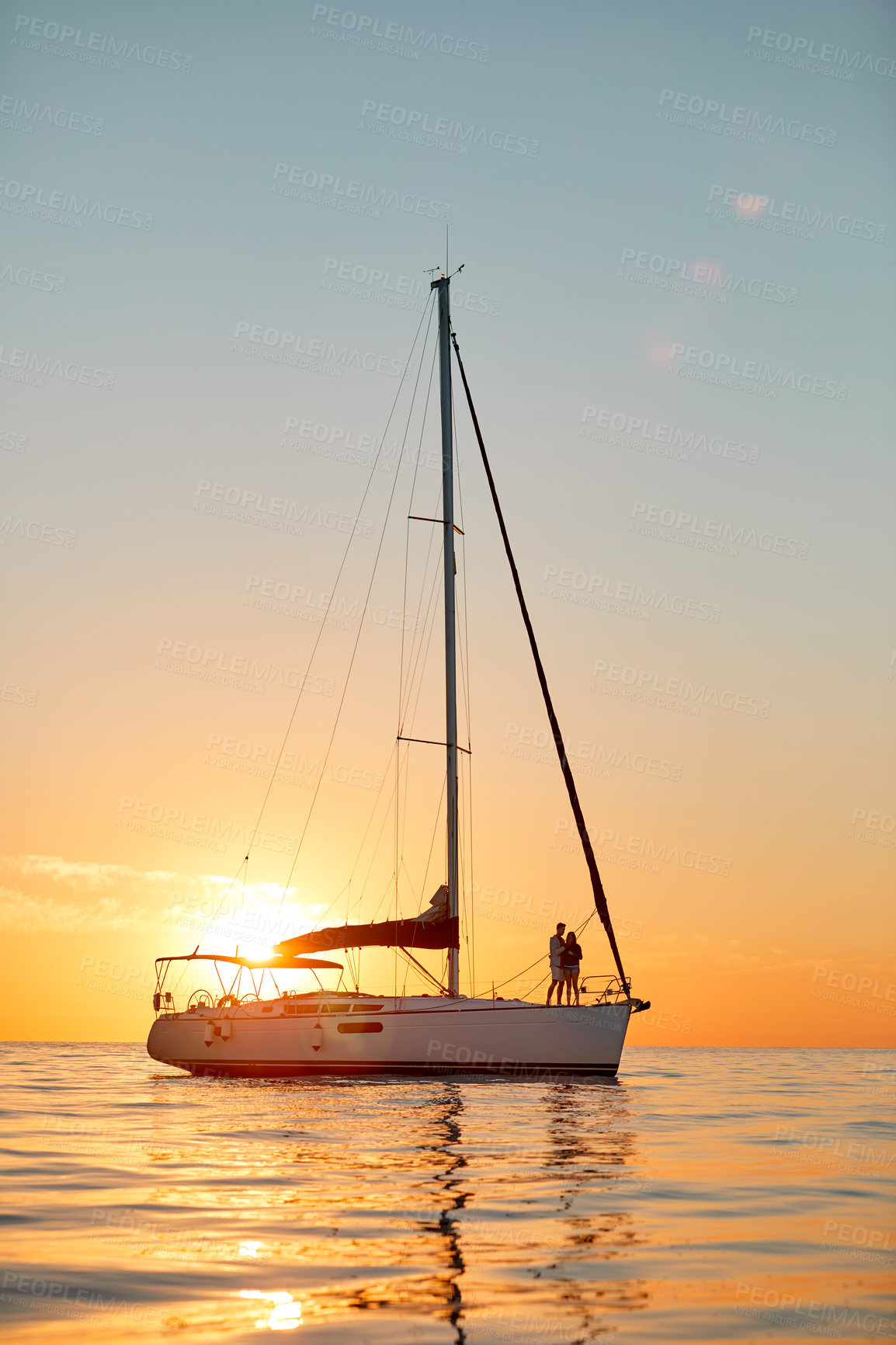 Buy stock photo Sunset, sailboat or couple with travel on ocean, adventure or transport with scenery, space and bonding. Sky, people and relax on yacht for luxury tropical vacation, getaway or exploring outdoor