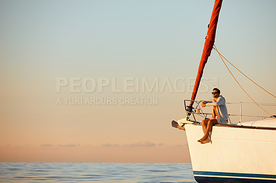 Buy stock photo Shot of a young man going for an ocean cruise on a boat