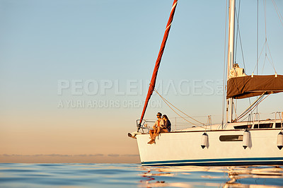 Buy stock photo Shot of a young couple enjoying a cruise out on the ocean