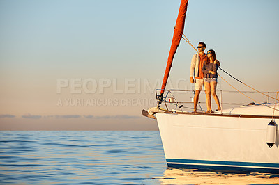 Buy stock photo Shot of a young couple enjoying a cruise out on the ocean