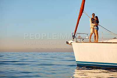 Buy stock photo Shot of a young couple enjoying a cruise out on the ocean