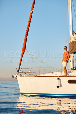 Buy stock photo Shot of a young man going for an ocean cruise on a boat