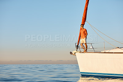 Buy stock photo Shot of a young man going for an ocean cruise on a boat