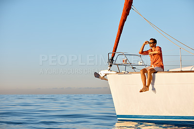 Buy stock photo Shot of a young man going for an ocean cruise on a boat
