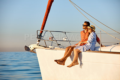 Buy stock photo Shot of a young couple enjoying a cruise out on the ocean