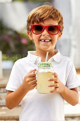 Buy stock photo Portrait of an adorable little boy drinking lemonade on a summer's day outdoors