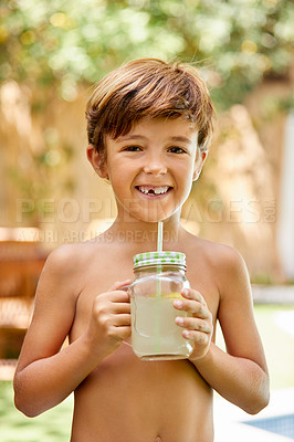 Buy stock photo Portrait of an adorable little boy drinking lemonade next to a swimming pool in the backyard